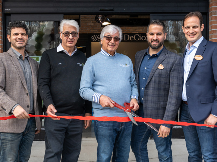 The DeCicco brothers and their sons cutting a ribbon